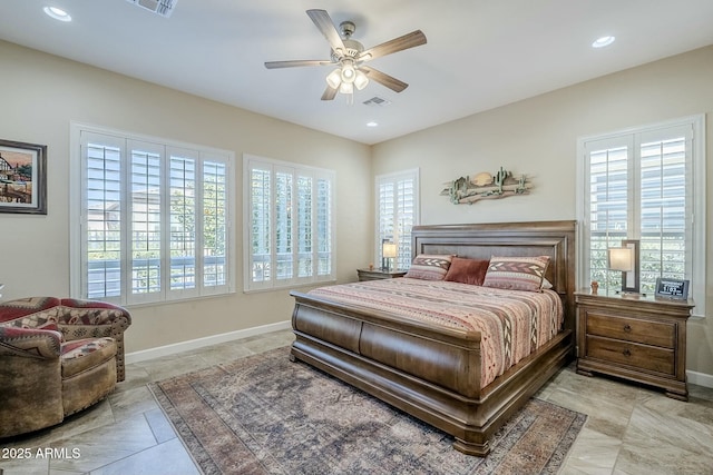 bedroom featuring ceiling fan and multiple windows