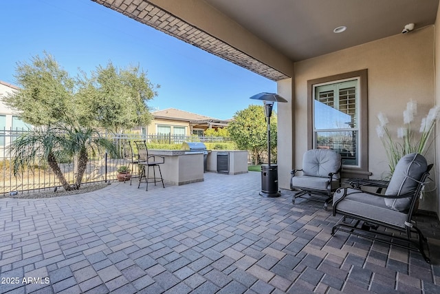 view of patio with an outdoor kitchen and an outdoor bar