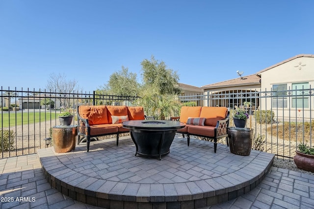 view of patio / terrace featuring an outdoor living space with a fire pit