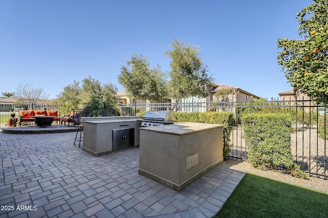 view of patio featuring exterior kitchen and grilling area