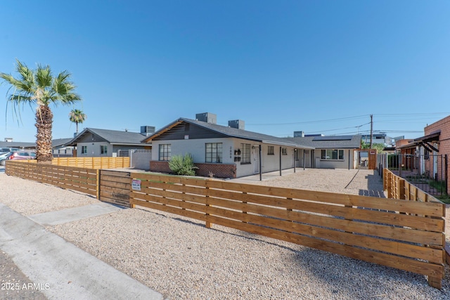 2608 W Pierson St, Phoenix, AZ 85017 - ranch-style house featuring a fenced front yard, roof mounted solar panels, a gate, a chimney, and a residential view