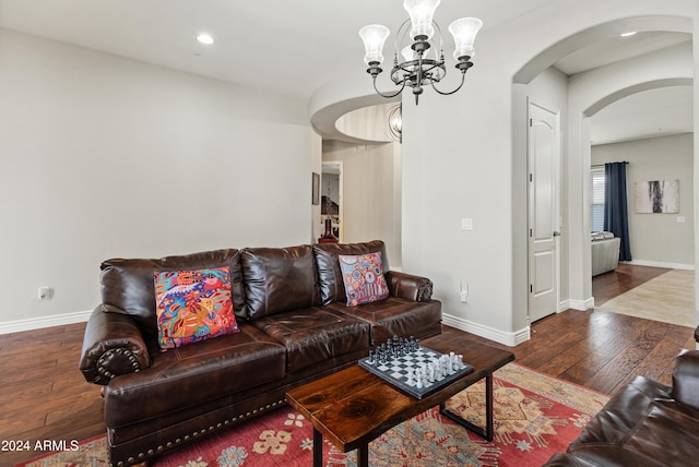 living room with dark hardwood / wood-style floors and a chandelier