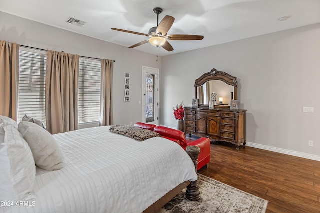 bedroom featuring multiple windows, dark hardwood / wood-style flooring, and ceiling fan