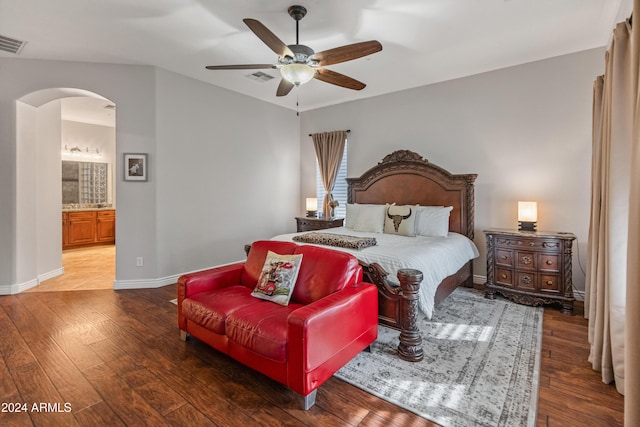 bedroom with wood-type flooring, ensuite bathroom, and ceiling fan