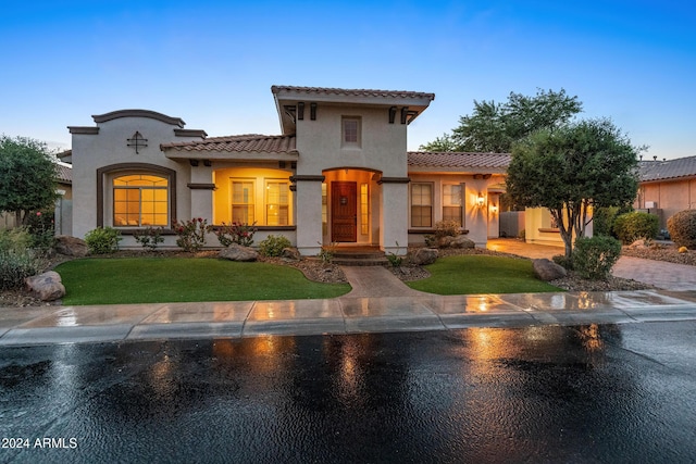 mediterranean / spanish-style house featuring a yard