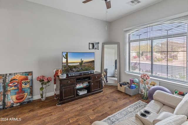 living room featuring ceiling fan and dark hardwood / wood-style flooring