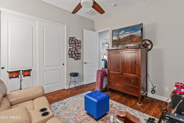 sitting room featuring ceiling fan and dark hardwood / wood-style floors