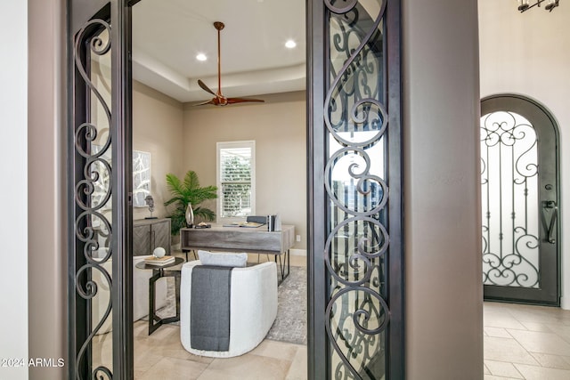 tiled entryway with ceiling fan