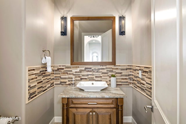 bathroom with vanity and tasteful backsplash