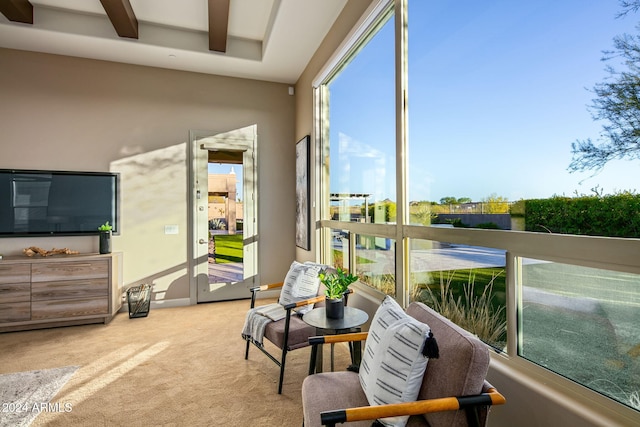 sunroom featuring beamed ceiling