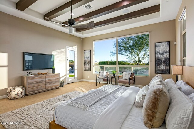 carpeted bedroom with beam ceiling and ceiling fan