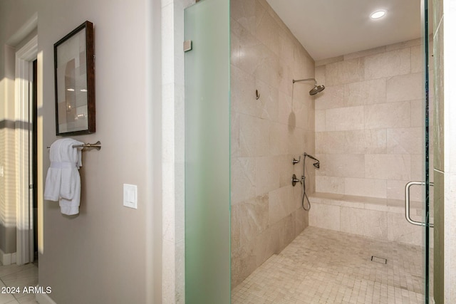 bathroom featuring tile patterned flooring and an enclosed shower