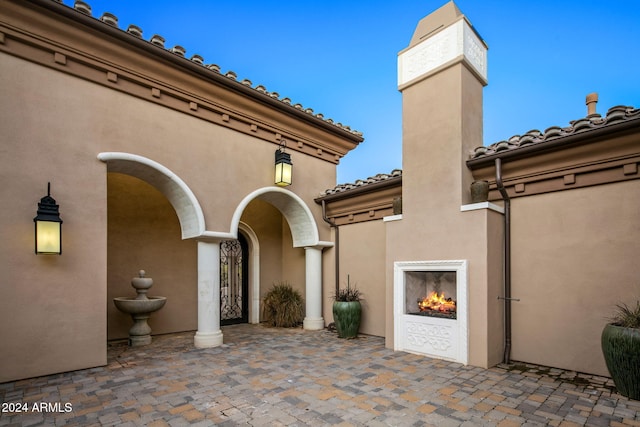 view of patio featuring exterior fireplace