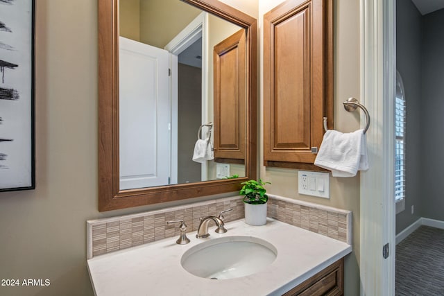 bathroom with vanity and tasteful backsplash