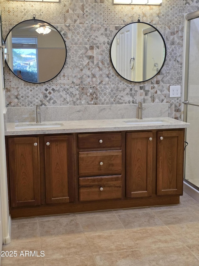 22508 W Antelope Trl, Buckeye, AZ 85326 - full bathroom featuring double vanity, tile walls, a shower stall, and backsplash