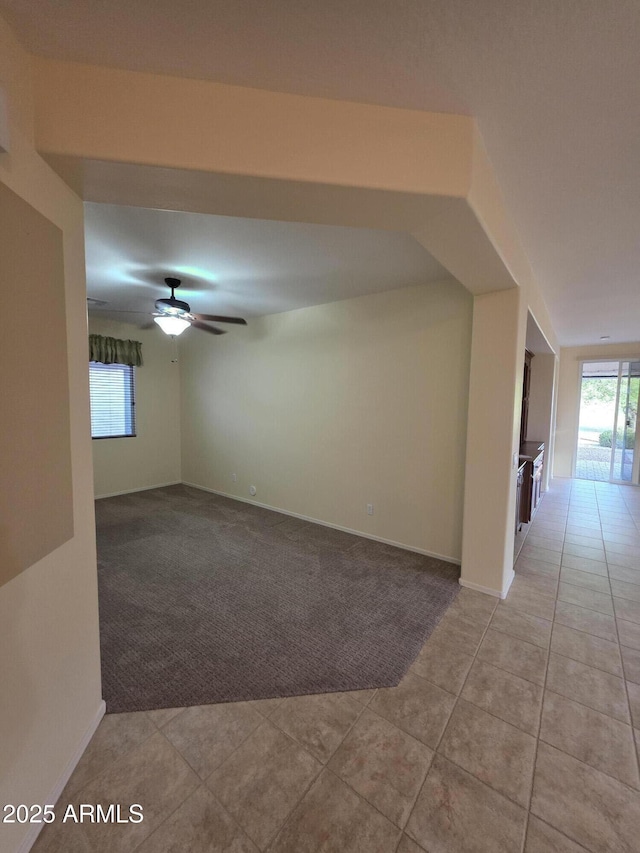 22508 W Antelope Trl, Buckeye, AZ 85326 - carpeted spare room with a ceiling fan, tile patterned flooring, and baseboards