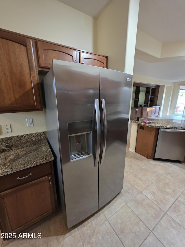 22508 W Antelope Trl, Buckeye, AZ 85326 - kitchen with stainless steel appliances, dark stone countertops, and light tile patterned flooring