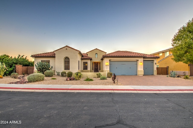 mediterranean / spanish-style home featuring a garage