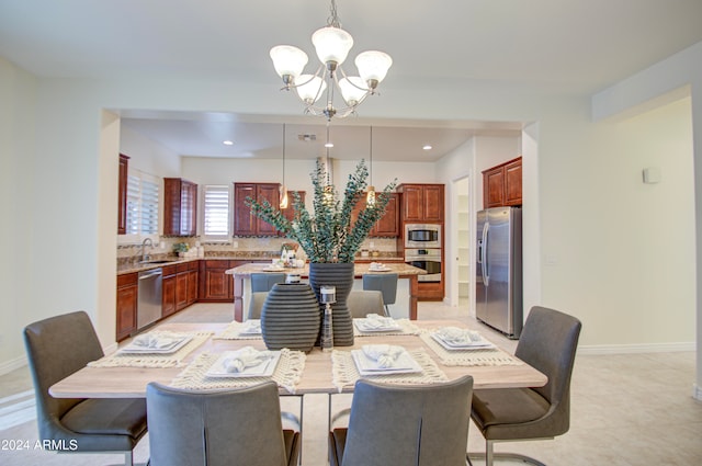 dining space with sink and an inviting chandelier