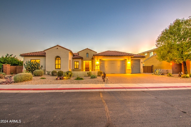 mediterranean / spanish-style house with a garage