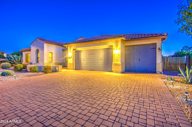 mediterranean / spanish home with a garage