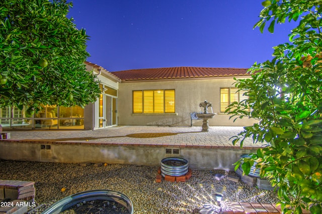 back of house with a patio