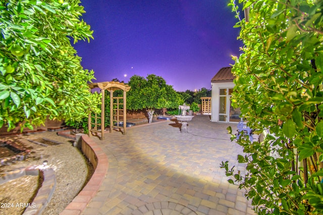 patio terrace at dusk featuring french doors