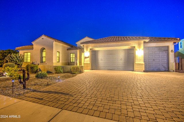 mediterranean / spanish-style home with a garage