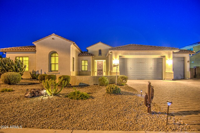 mediterranean / spanish-style home with a garage