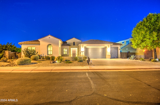 mediterranean / spanish home featuring a garage