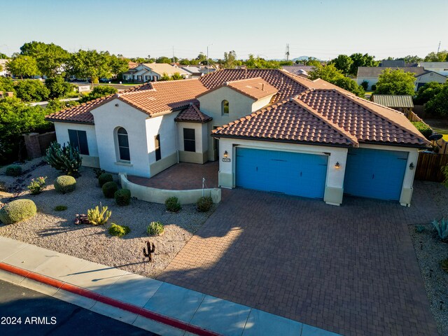 mediterranean / spanish-style home with a garage