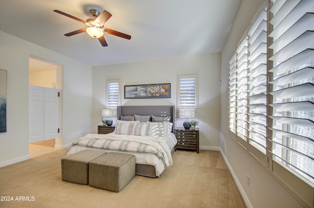 bedroom with light colored carpet and ceiling fan