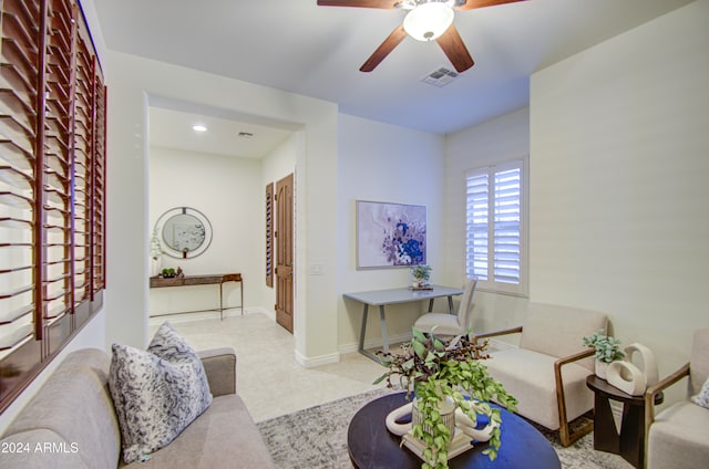 living room featuring light colored carpet and ceiling fan