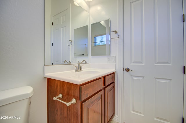 bathroom featuring vanity and toilet