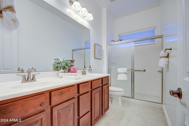 bathroom featuring walk in shower, tile patterned floors, vanity, and toilet