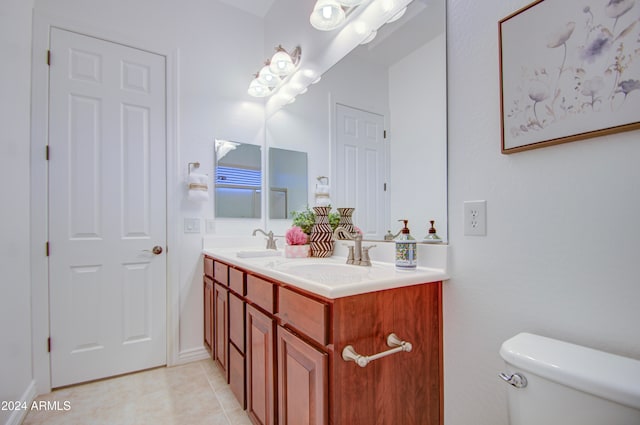 bathroom with tile patterned flooring, vanity, and toilet