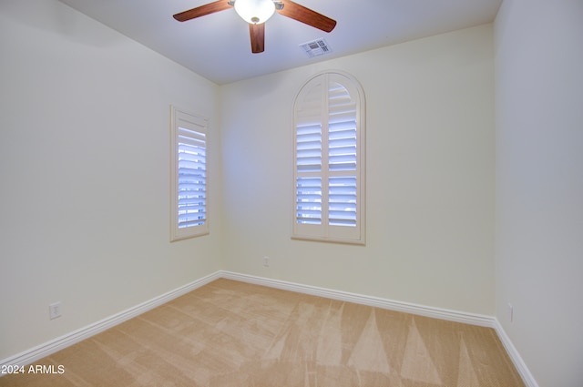 carpeted empty room with ceiling fan