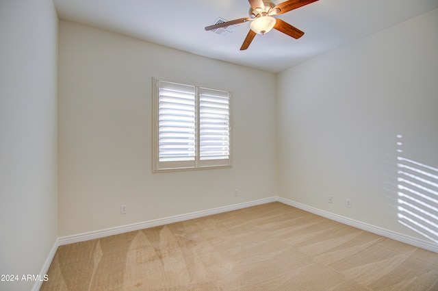 carpeted spare room with ceiling fan