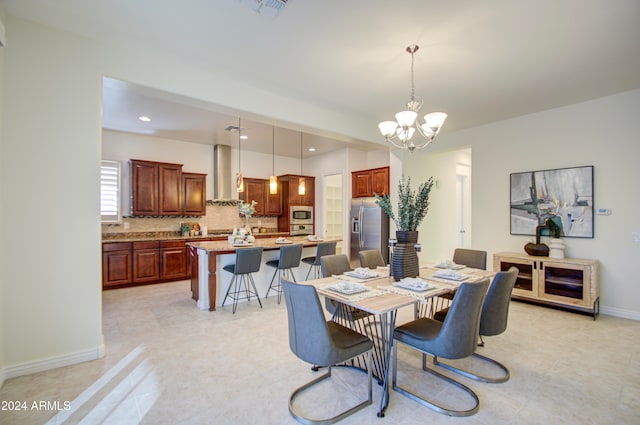 tiled dining room with a chandelier