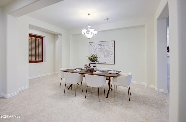 dining space featuring an inviting chandelier