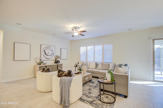 tiled living room with a wealth of natural light and ceiling fan