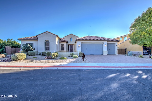 mediterranean / spanish-style home featuring a garage