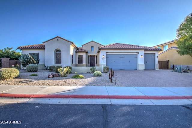 mediterranean / spanish-style home with a garage