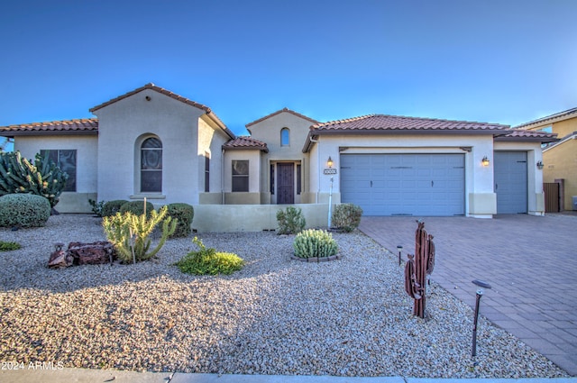 mediterranean / spanish-style house featuring a garage