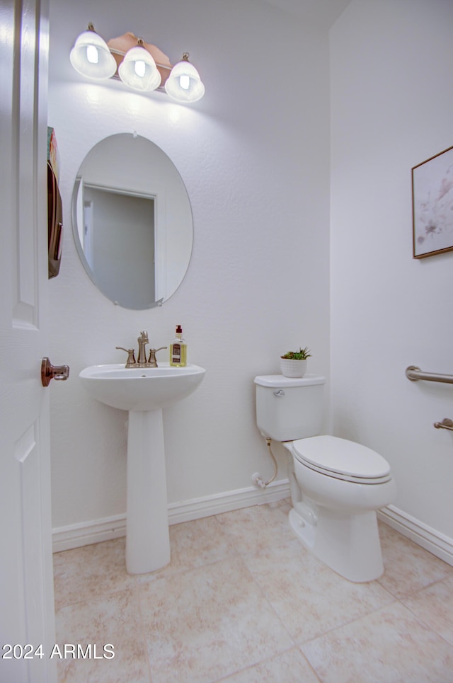 bathroom with toilet and tile patterned flooring