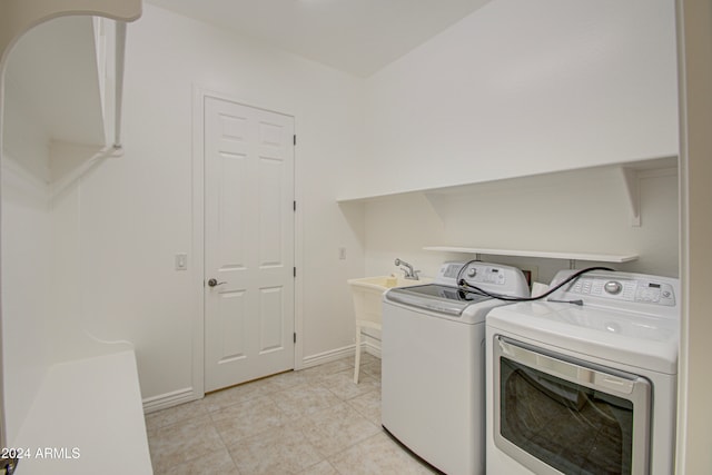 laundry room with washing machine and clothes dryer and light tile patterned flooring