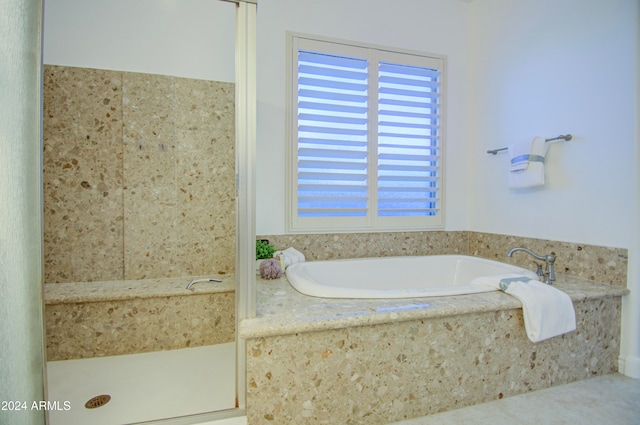 bathroom featuring tiled bath