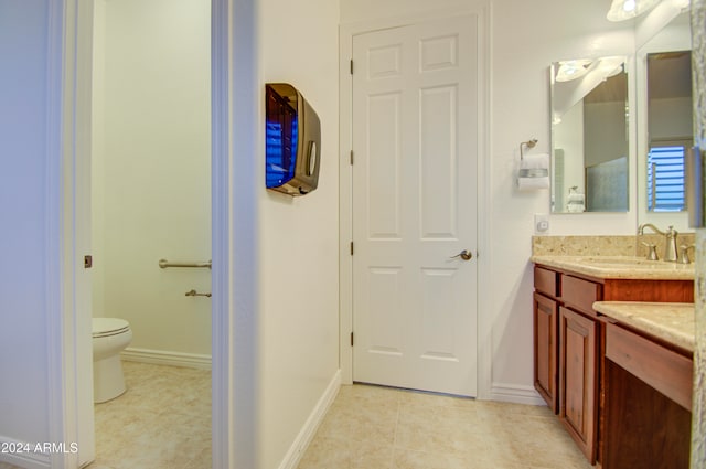 bathroom with tile patterned floors, vanity, and toilet