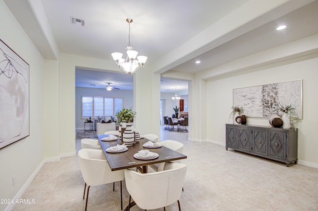 dining room with ceiling fan with notable chandelier