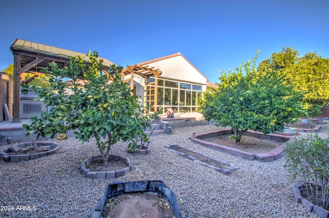 back of house featuring a gazebo, a fire pit, and a patio area